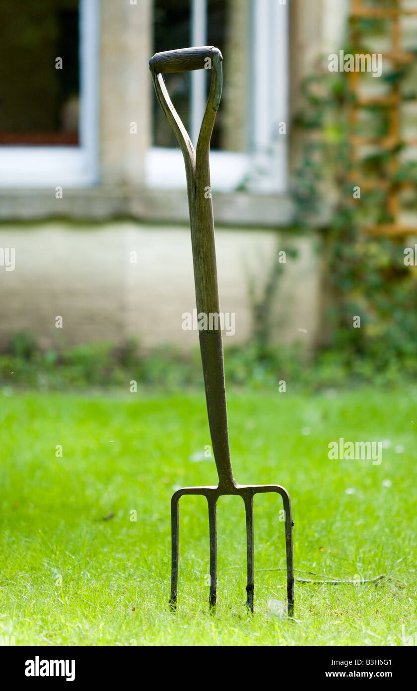 Garden fork stuck in the ground outside a house Stock Photo Alamy