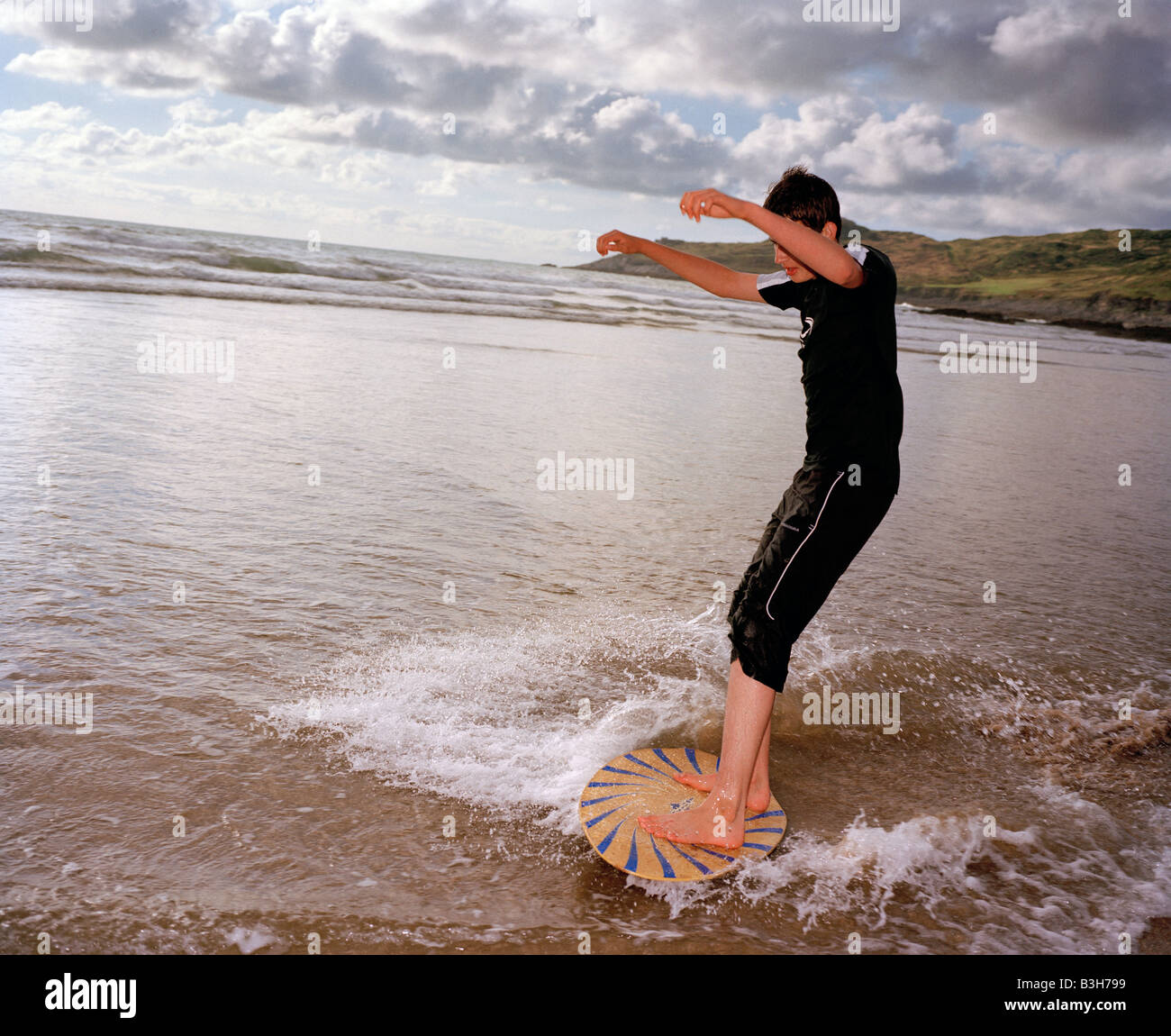 Teenager on a skimboard North Devon England UK Stock Photo