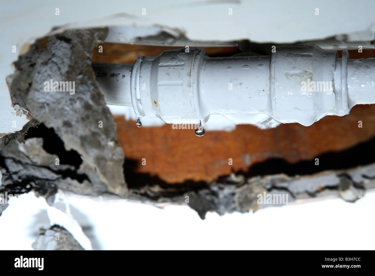 Burst pipe looking through damaged ceiling Stock Photo Alamy