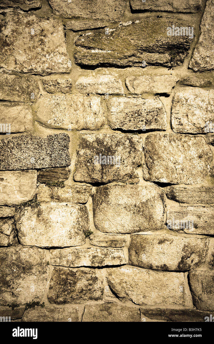 Old stone wall with a grungy sepia tone Stock Photo