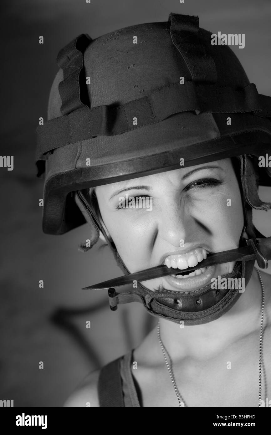 young woman at army with knife Stock Photo