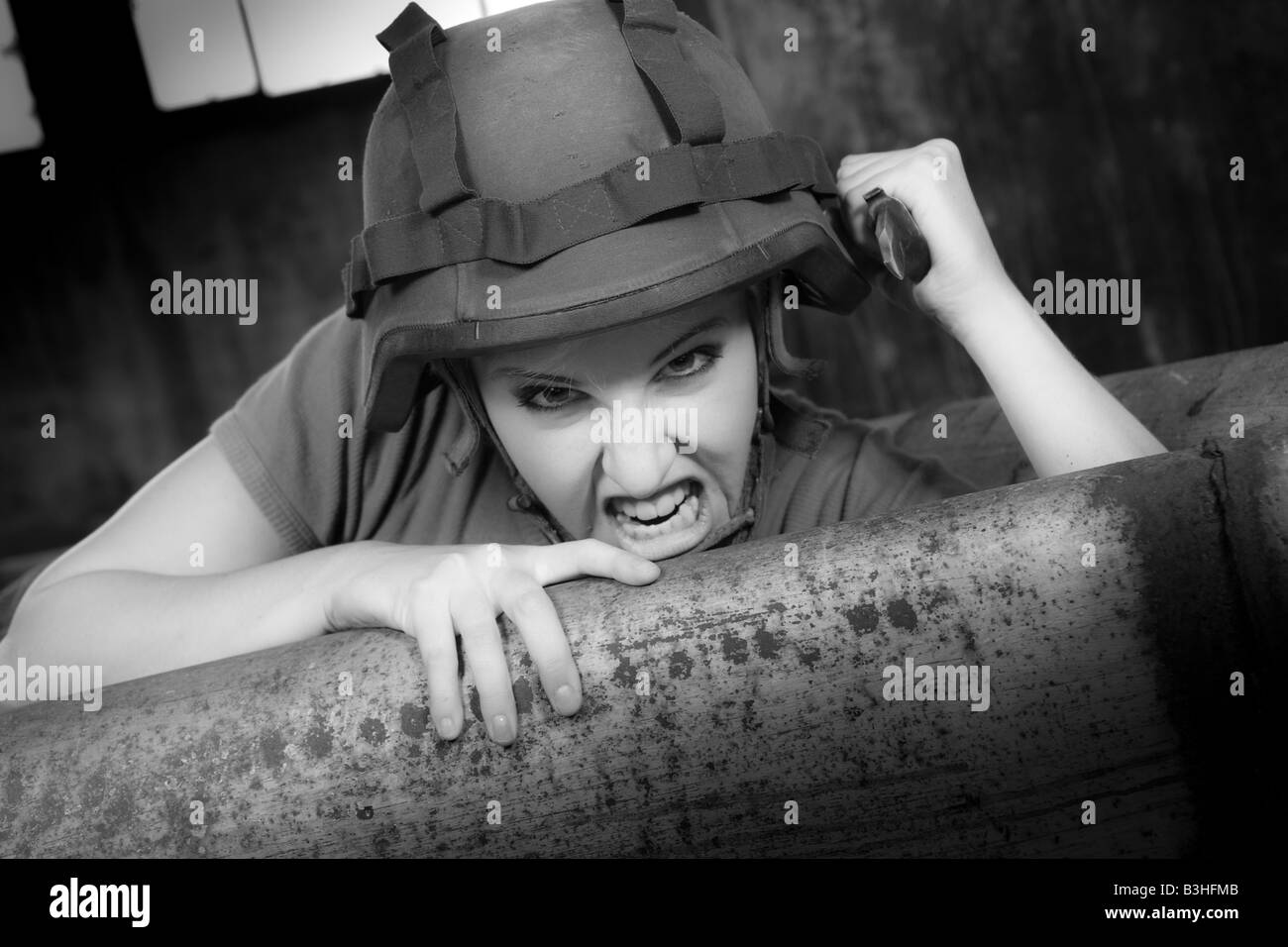 army woman attacking with knife Stock Photo