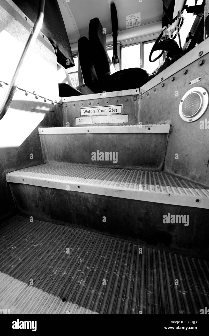 The gargatuan steps a young student sees when boarding a school bus for the first time. Stock Photo