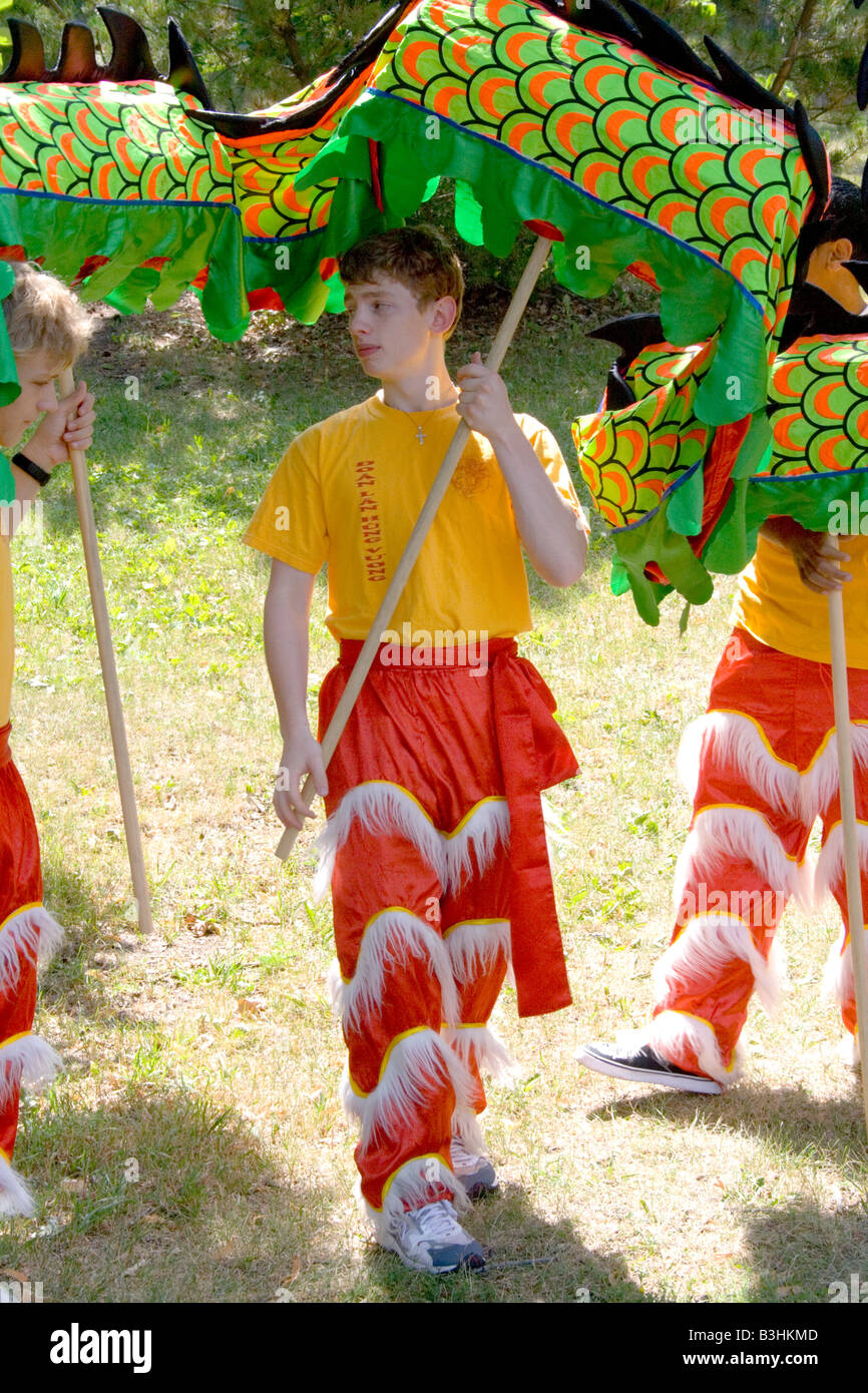 Colorful legs of the festival dance team carry dragon to ceremony