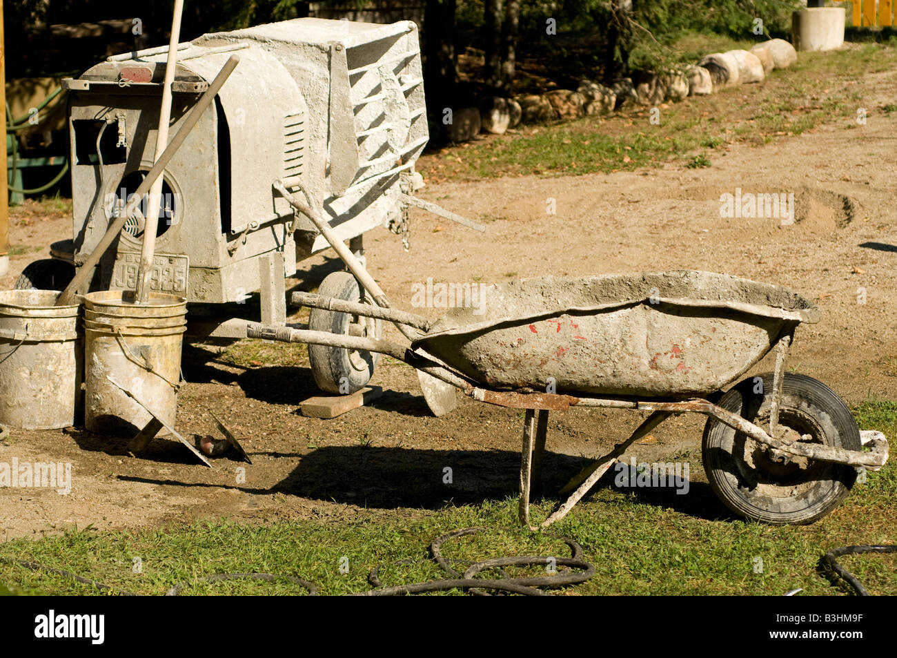 wheelbarrow and cement mixer Stock Photo Alamy