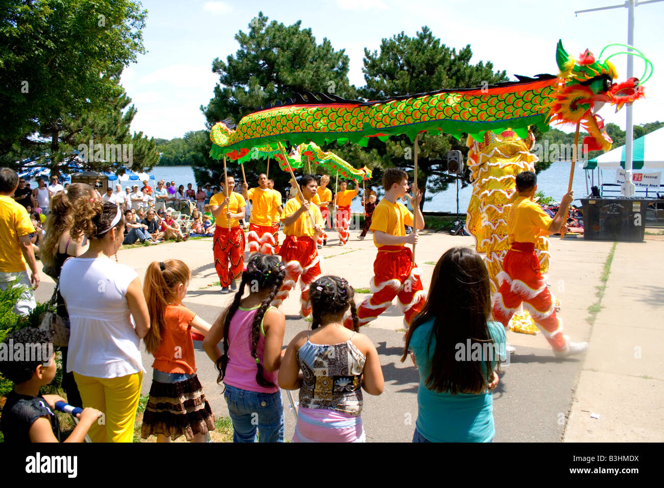 Asian dragon pole dancers perform ceremony before attentive audience