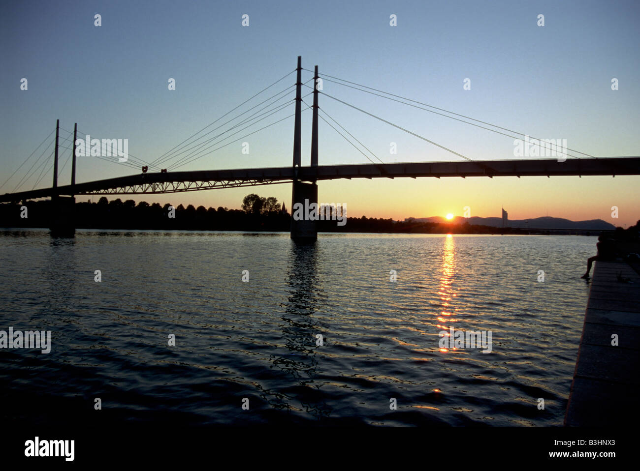 pedestrian bridge over the Neue Donau in the evening Stock Photo