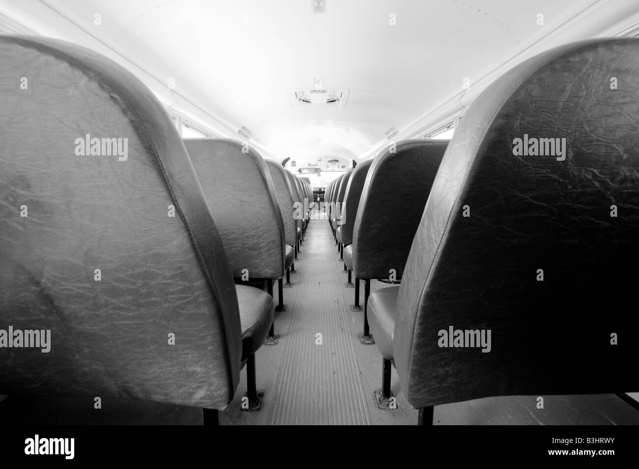 Rows of school bus seats waiting for occupants. Stock Photo