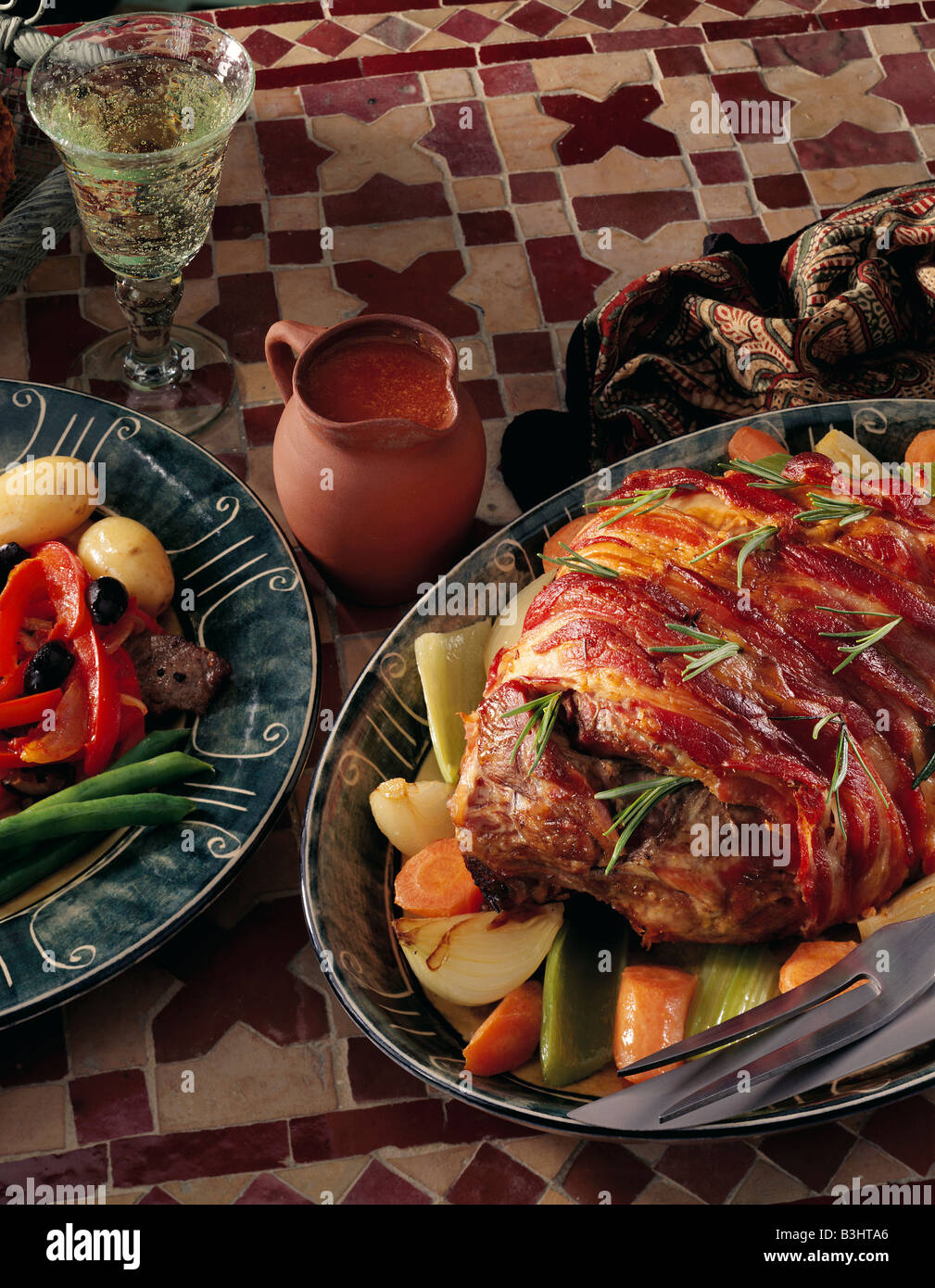 Whole roast lamb leg streaky bacon wrapped hires stock photography and