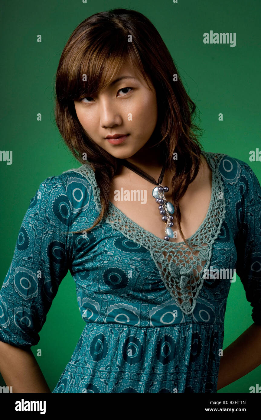 A beautiful asian woman in blue dress on green background Stock Photo ...