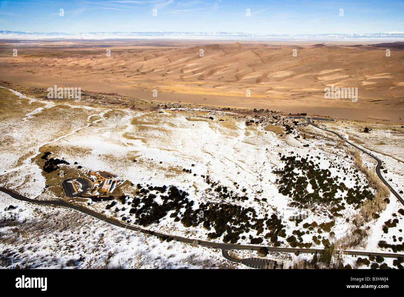 Aerial landscape of snowy plains and dunes in Great Sand Dunes National Park Colorado Stock Photo