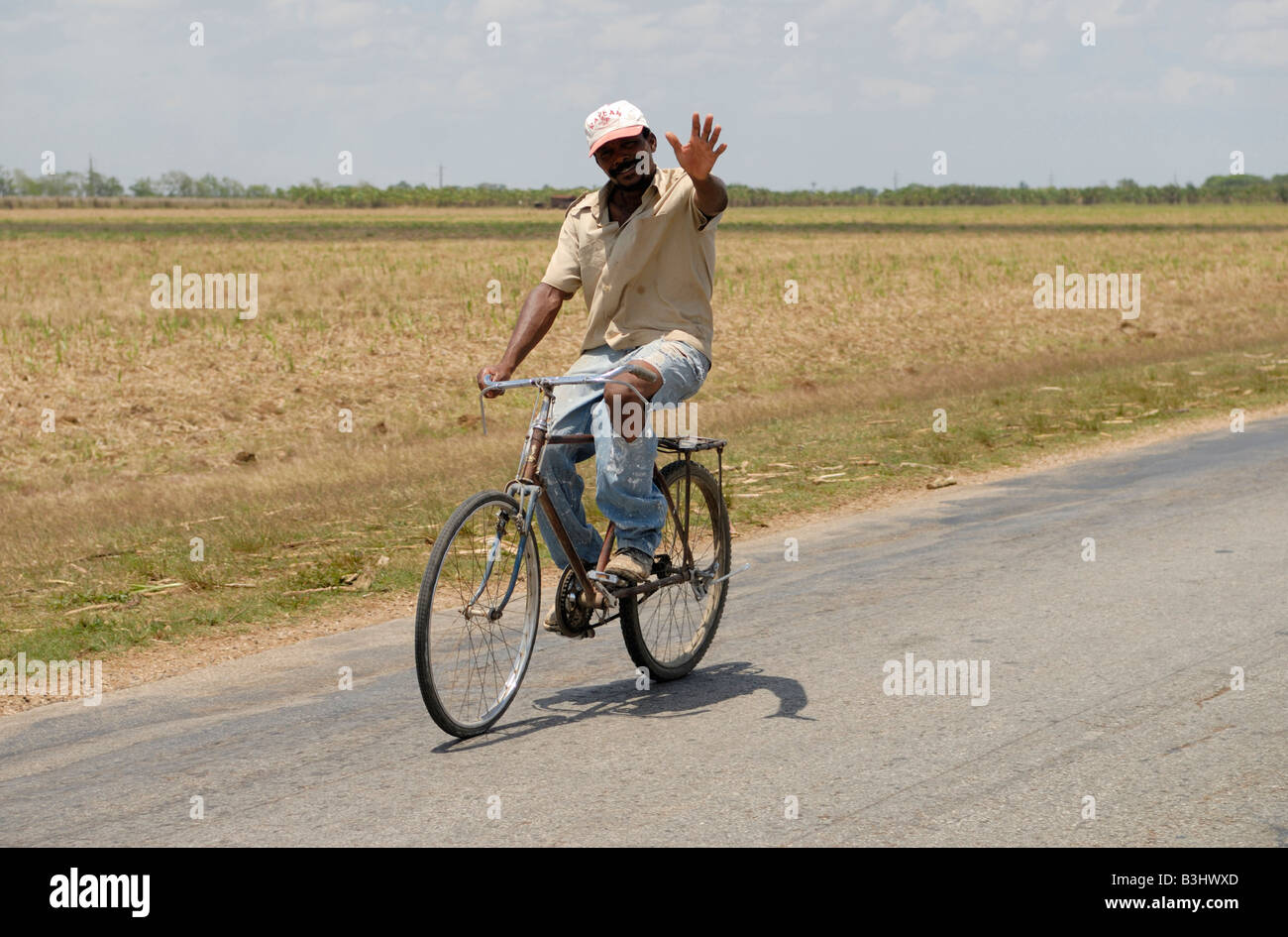 Friendly waving cuban man on a bicycle Ciego de Avilla province Cuba April 2007 Stock Photo