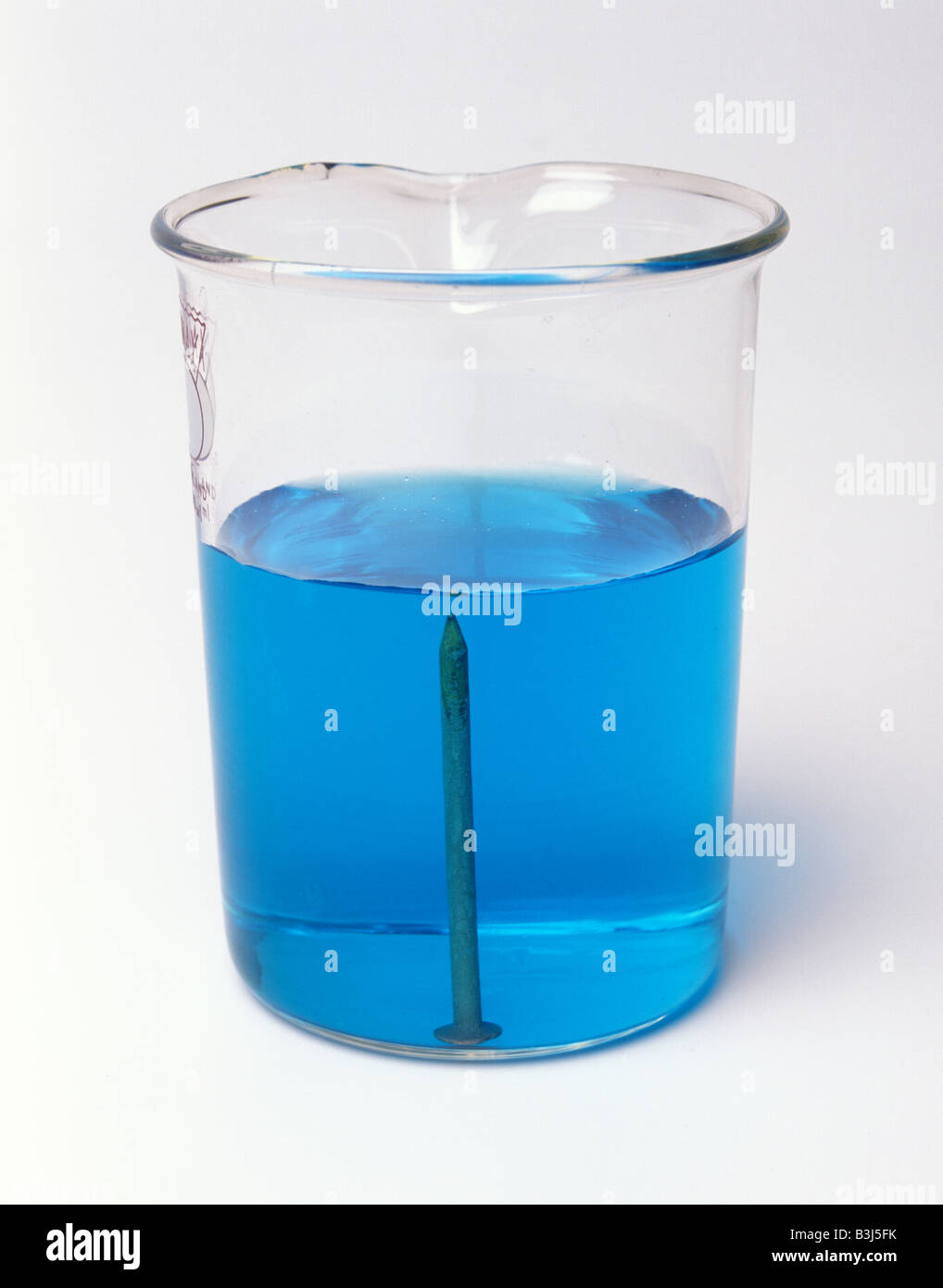 An iron nail in copper sulphate solution becomes coated with copper Stock Photo