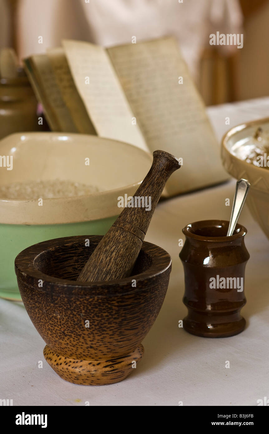 Pestle and mortar with mixing bowl, jar and spoon and recipe book in
