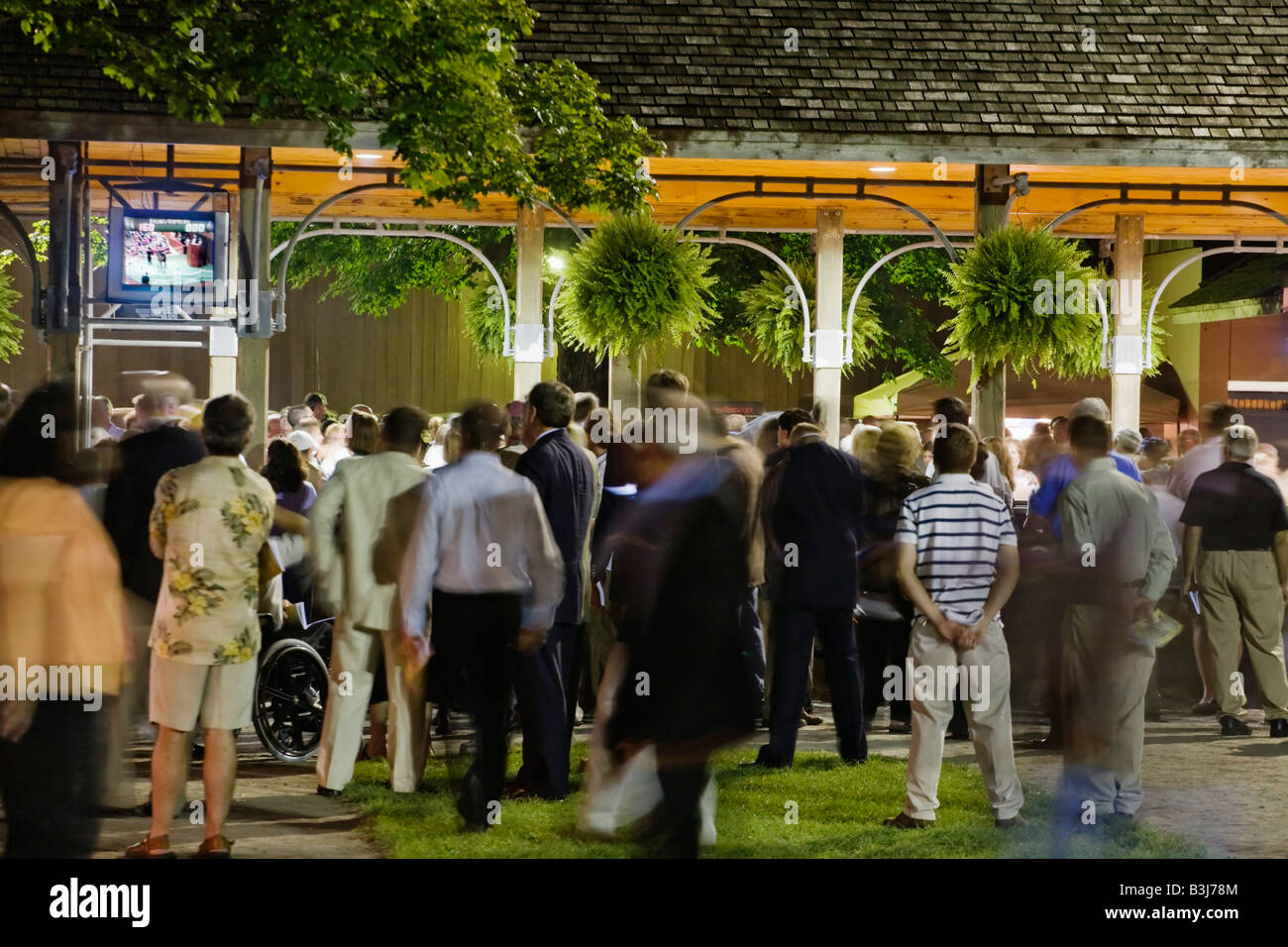 Watching auction on monitor at Fasig Tipton thoroughbred horse auction Saratoga Springs New York