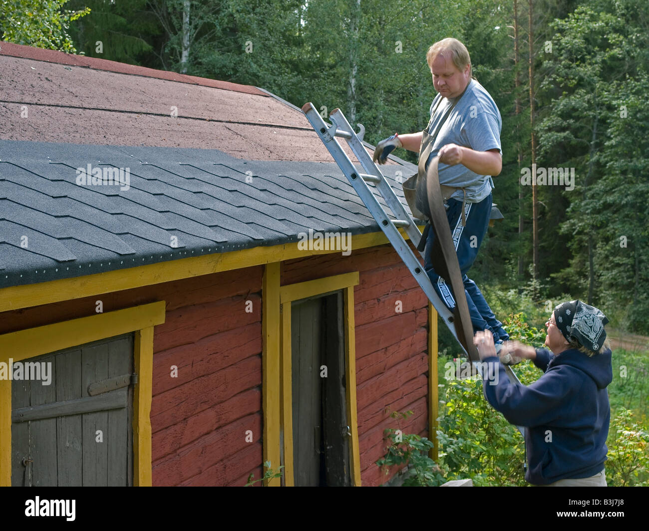 man and woman menting renovating remaking roofing cardboard roofing