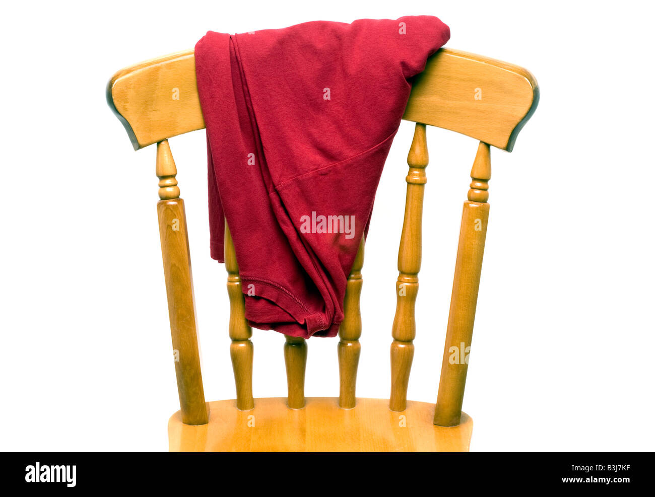 Red mans Tee T shirt on the back of a wooden chair back Stock Photo