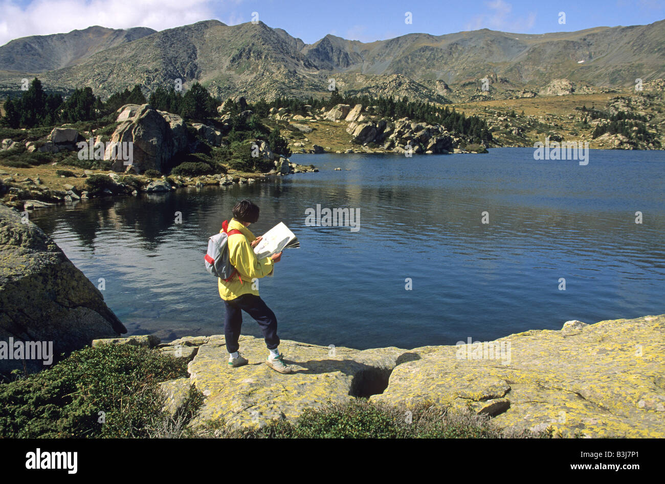 Woman hiker with a map in the Massif of Carlit, Pyrenees Orientales, France Stock Photo