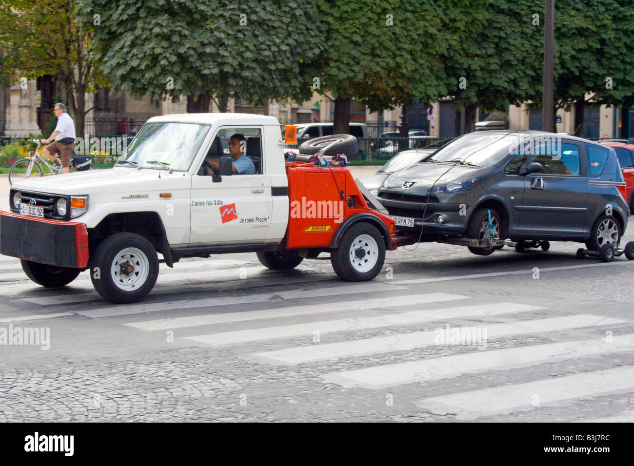 A car being towed by a french roadside rescue service in the city of ...