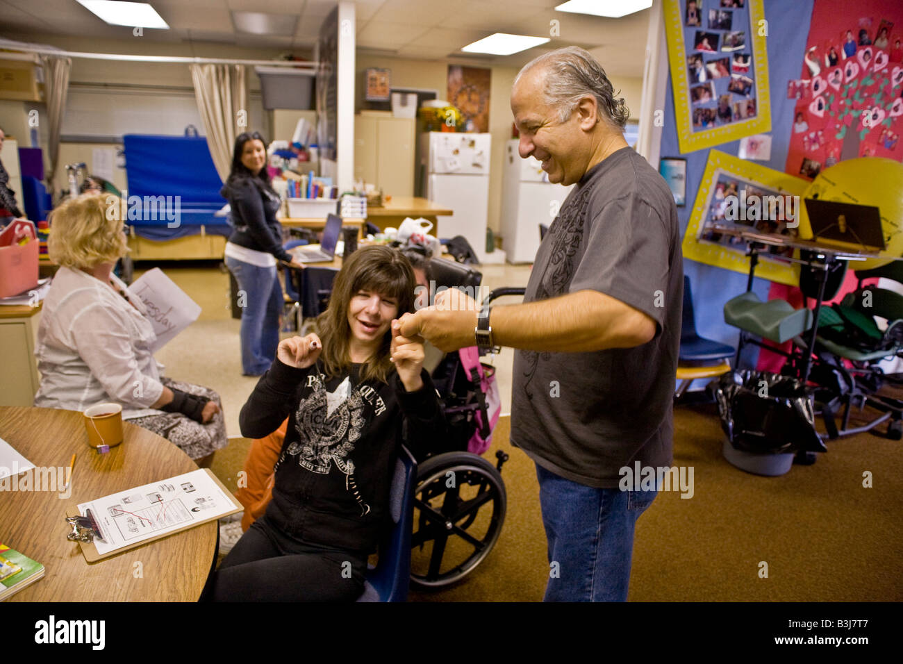 Specially trained teachers work with handicapped students at a California school legally obliged to give special needs schooling Stock Photo