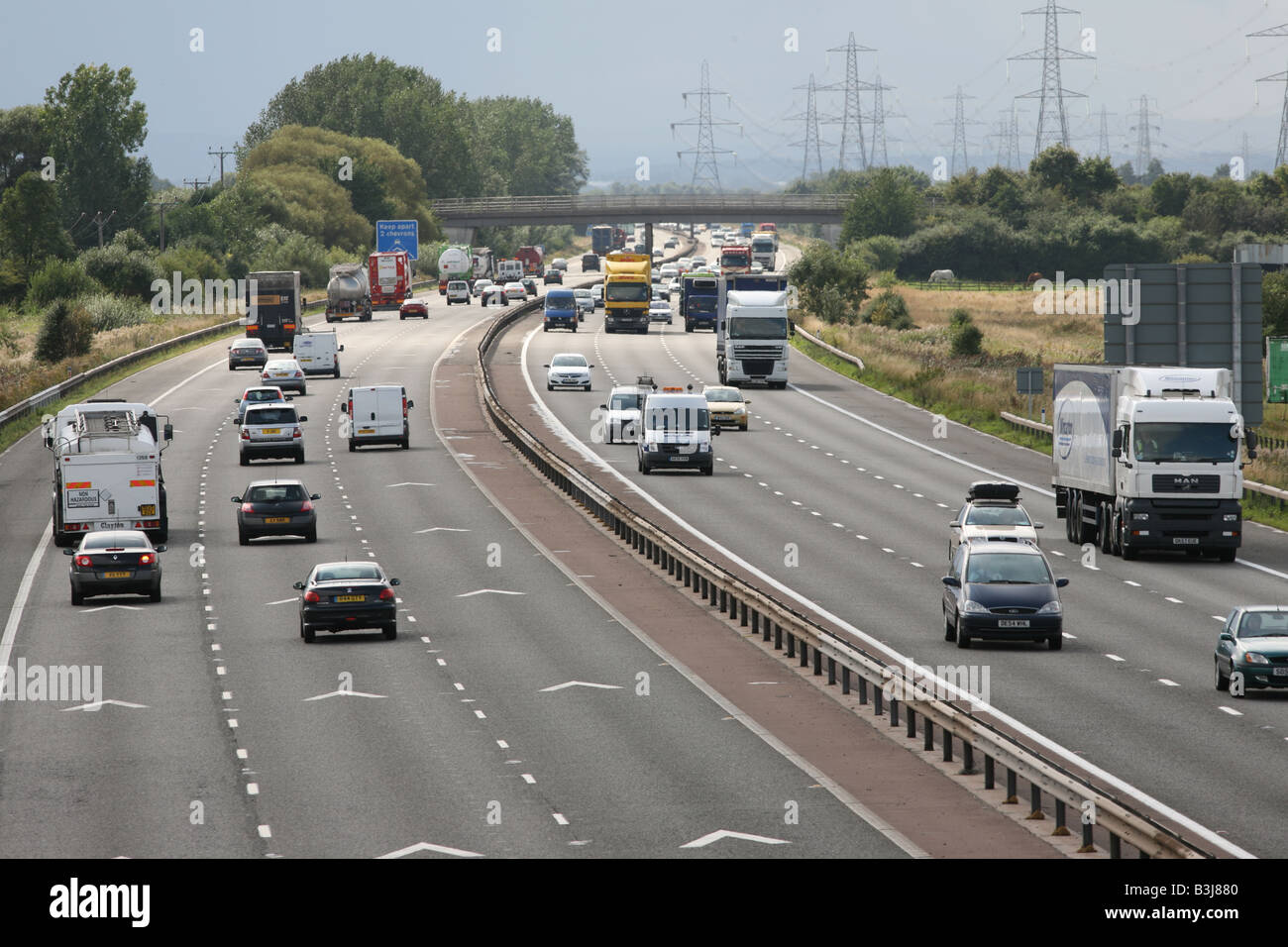 Keep apart 2 chevrons motorway road  markings and traffic on M56, Cheshire,UK Stock Photo