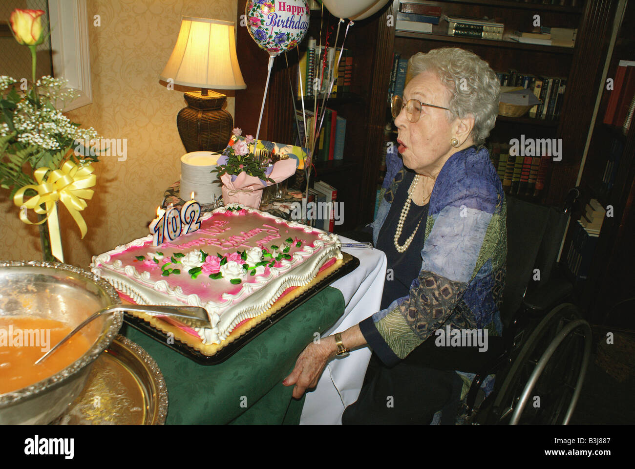 102 year old woman blowing out her birthday candles Stock Photo Alamy