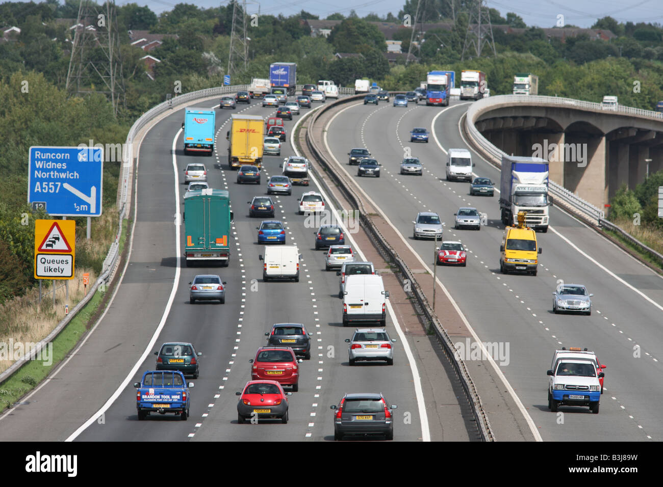 HGVs and cars traveling on M56 motorway, Cheshire,UK,EU Stock Photo