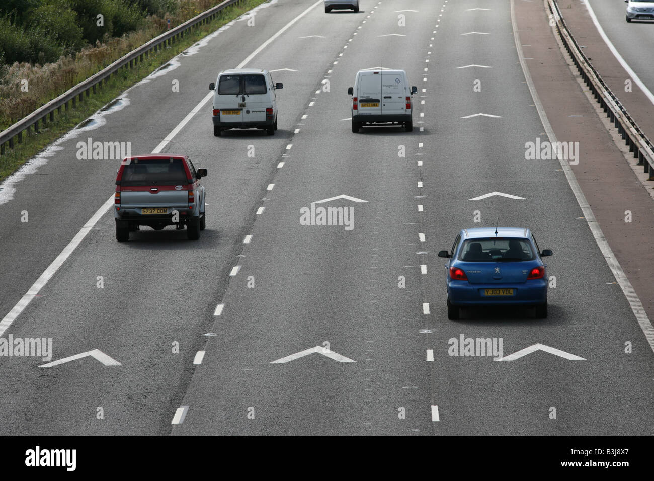 Keep apart 2 chevrons motorway road markings and traffic on M56, Cheshire,UK Stock Photo