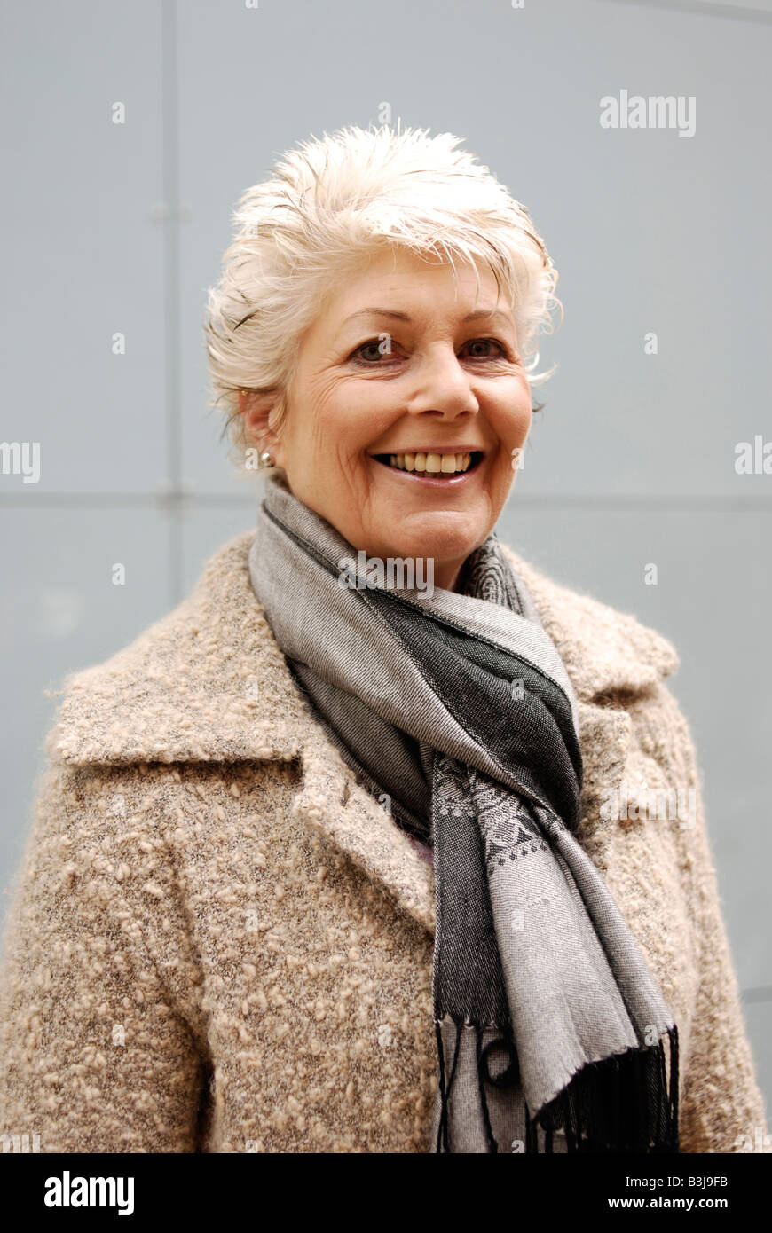 Attractive mature woman with a healthy happy smile in winter clothing Stock Photo
