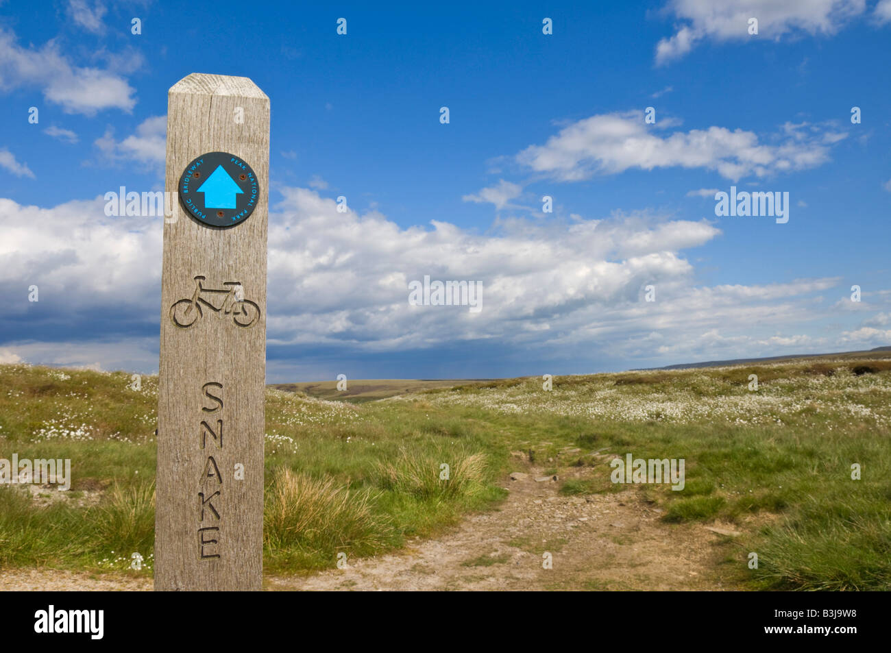 Public footpath wooden path marker signpost to the Snake Pass Bleaklow moor Derbyshire England UK GB EU Europe Stock Photo