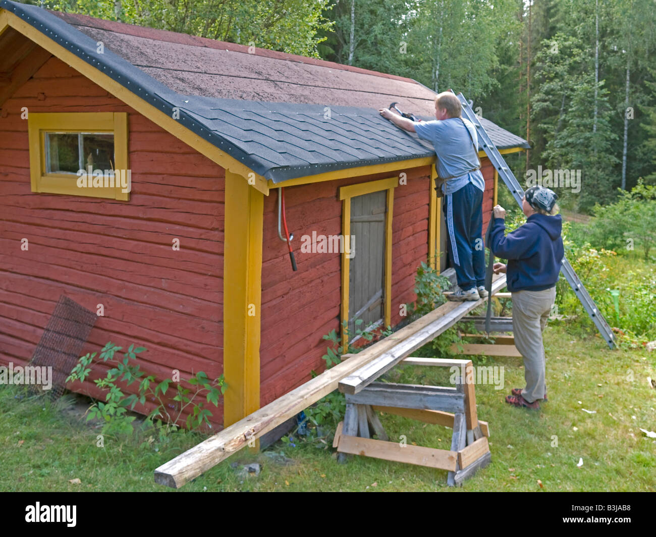 man and woman menting renovating remaking roofing cardboard roofing