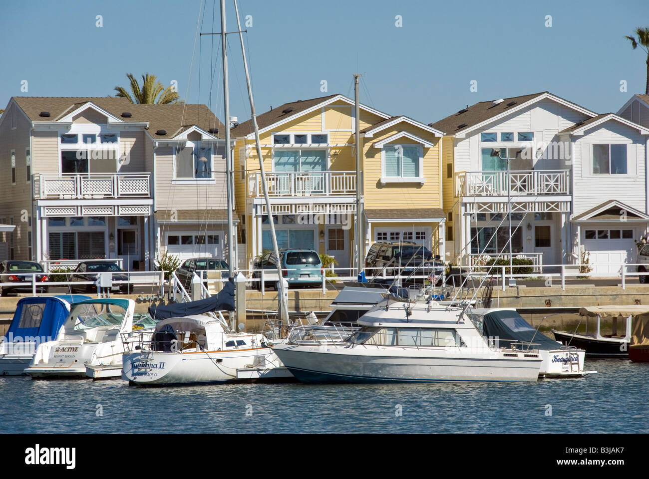 balboa peninsula balboa city newport beach, orange county, california, ca usa Boats docked in front of houses, homes, condos Stock Photo