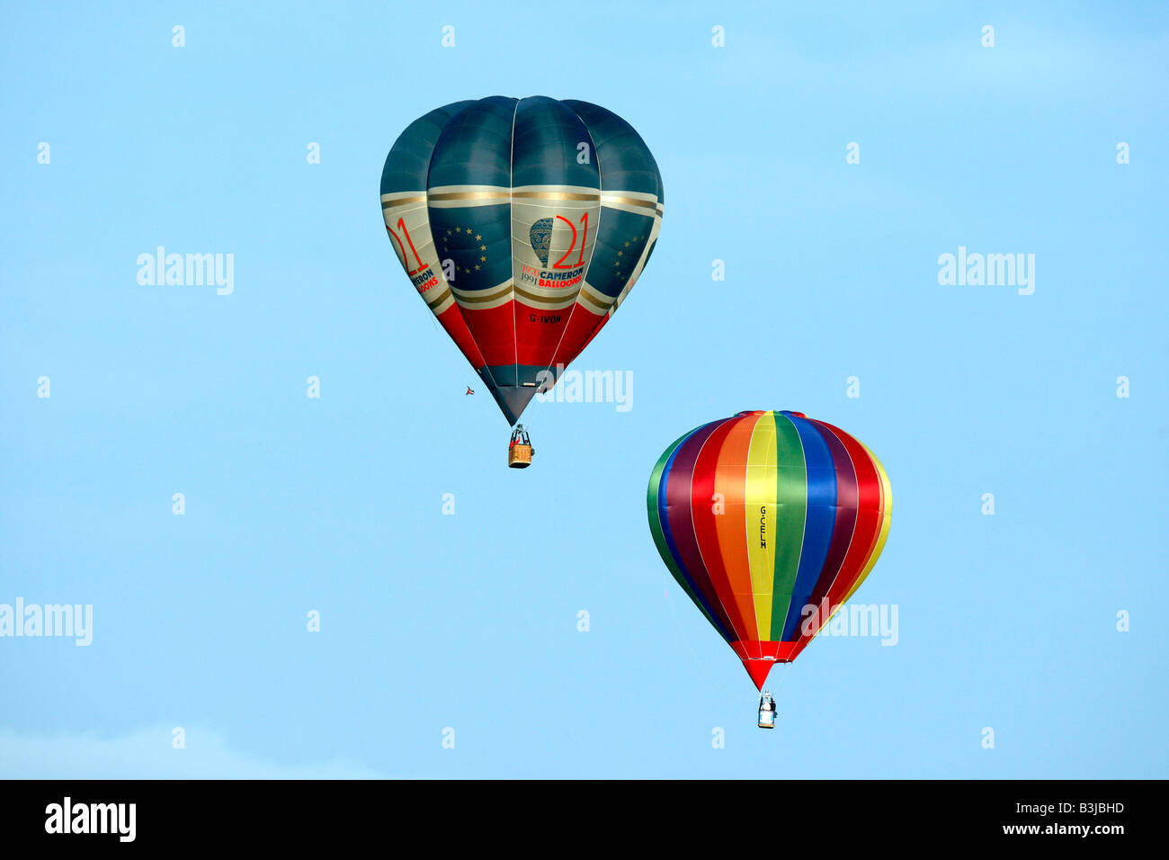 Two colourful hot air balloons against blue sky Stock Photo - Alamy