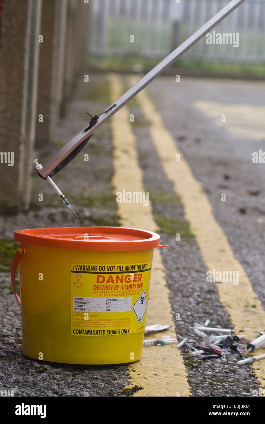 Picking up discarded needles Stock Photo Alamy