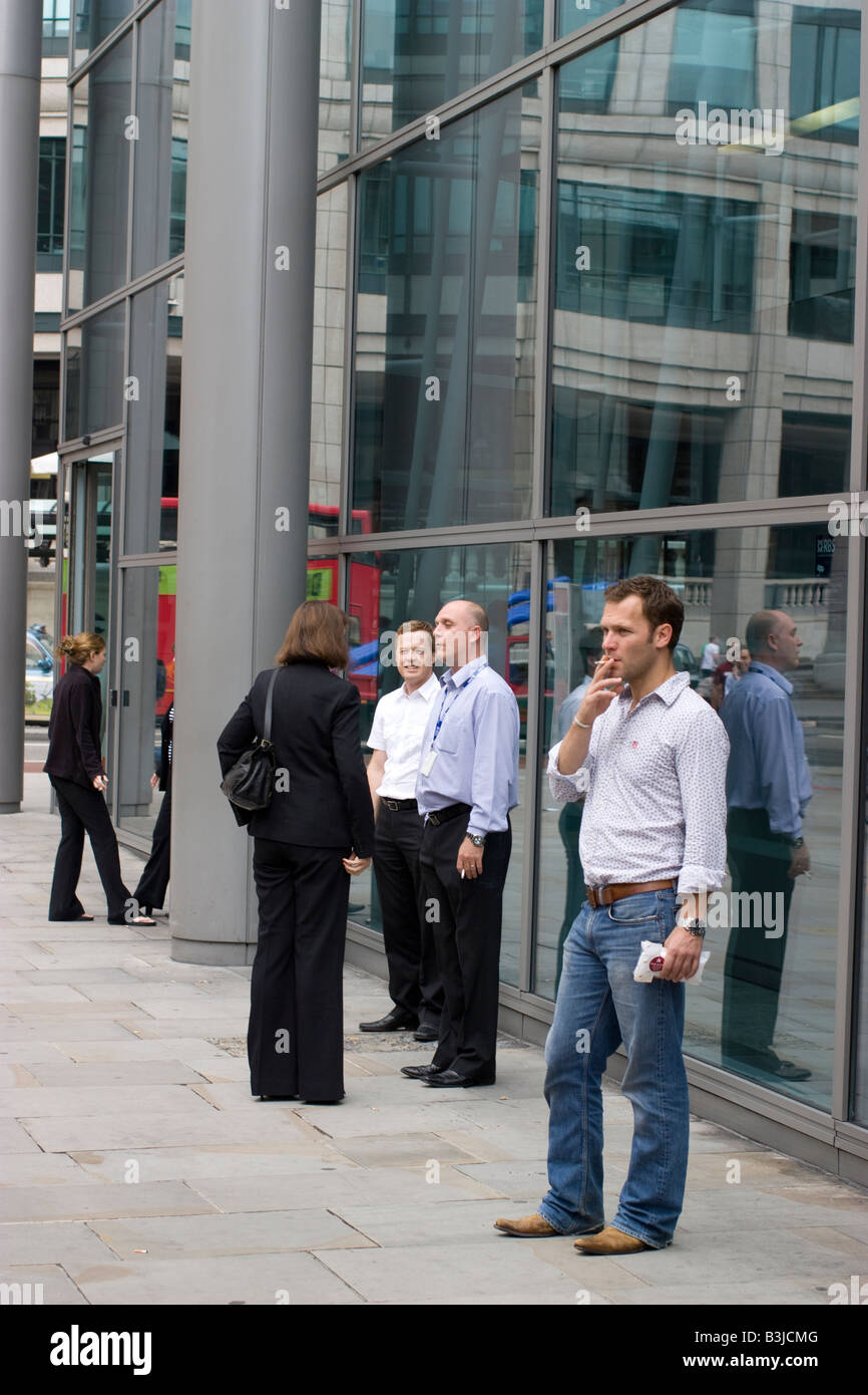 smoking smokers cigarettes smoking outside building during break Stock Photo