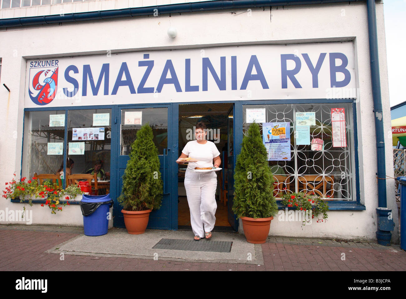 Wladyslawowo Poland customer at a fresh fried fish shop on the harbour quayside of this fishing port town Stock Photo