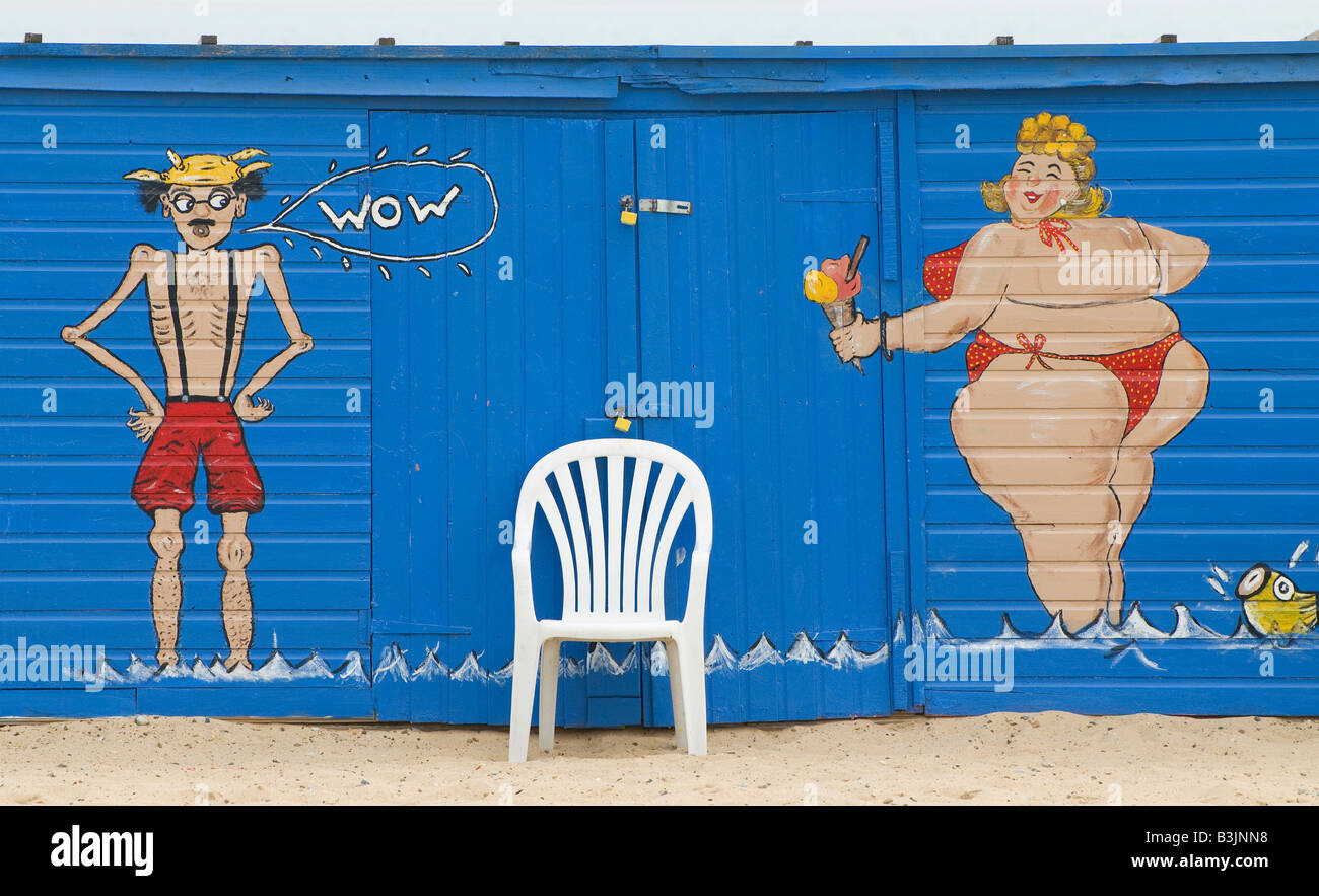saucy seaside couple painted on beach hut Stock Photo