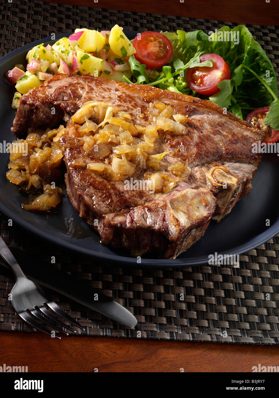 T bone steak and potato salad editorial food Stock Photo - Alamy