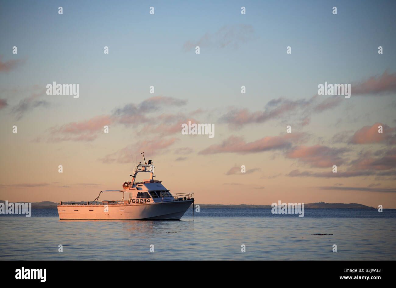 fishing boat anchored at sea Stock Photo - Alamy