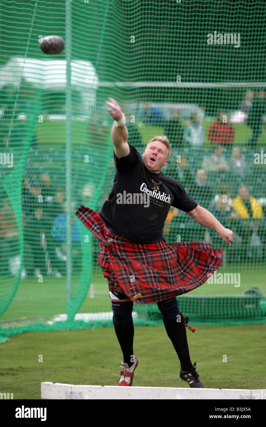 A Highland Heavy competitor throwing the stone at the Braemar Gathering, Aberdeenshire, Scotland, UK Stock Photo