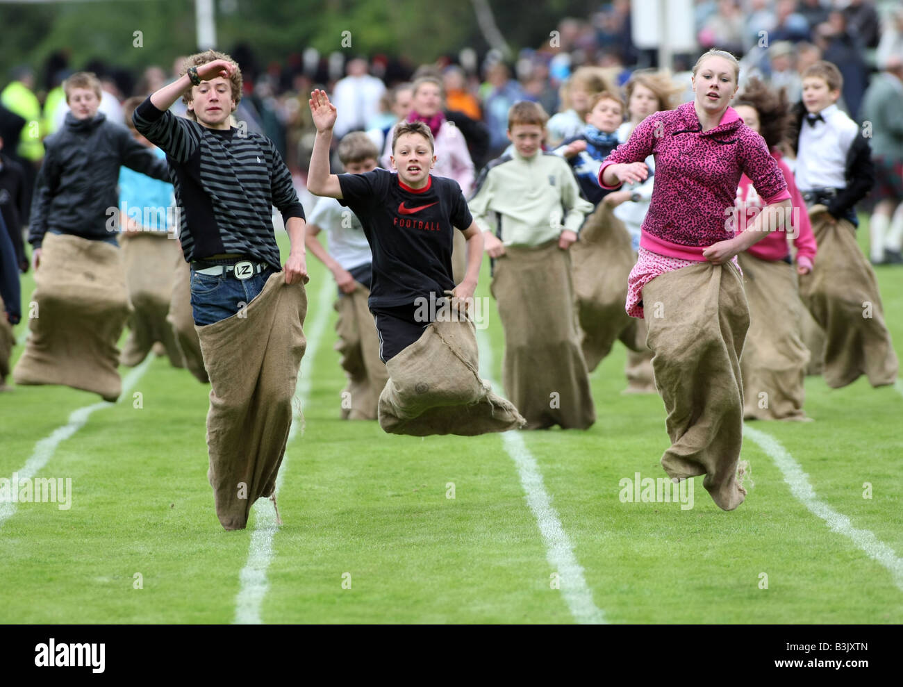 Children competing in an old fashioned traditional sack race in the UK Stock Photo