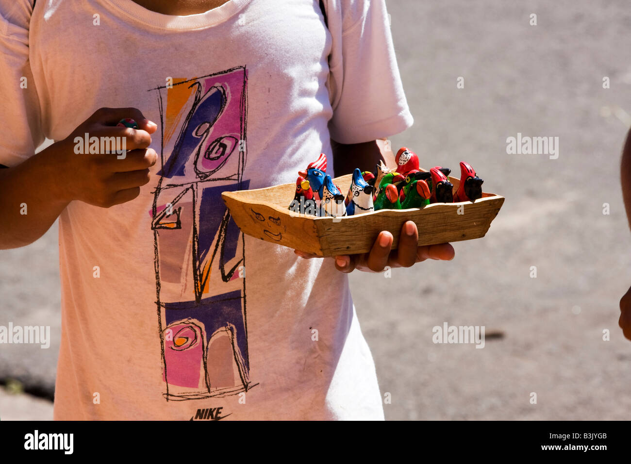 A local boy sells typical Nicaraguan pottery in front of the Cathedral Stock Photo