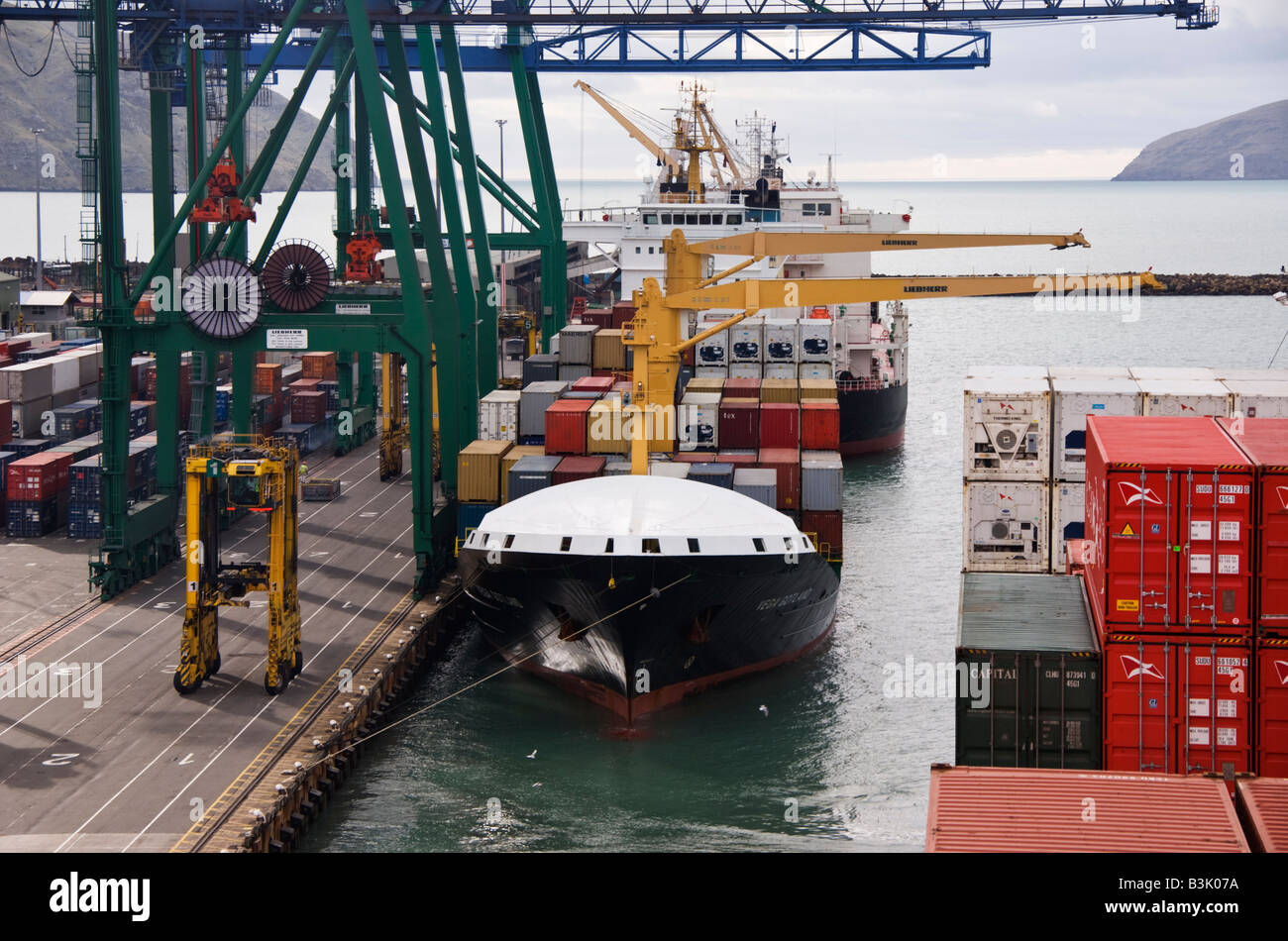 A view along the quayside of a container terminal from a ship that has just left the dock. Stock Photo