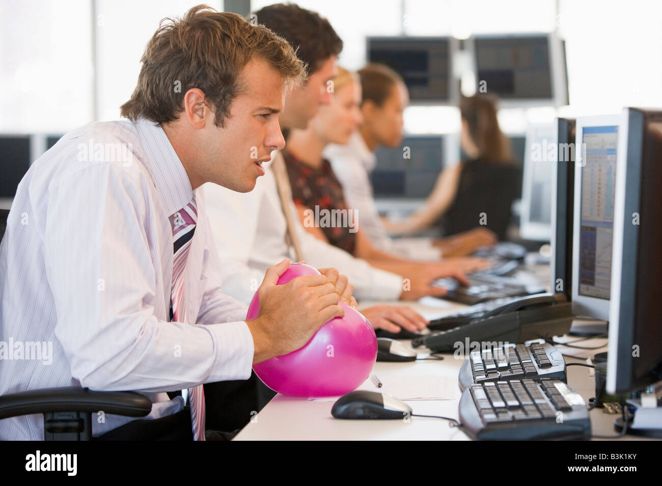 Businessman in office space with a ball Stock Photo