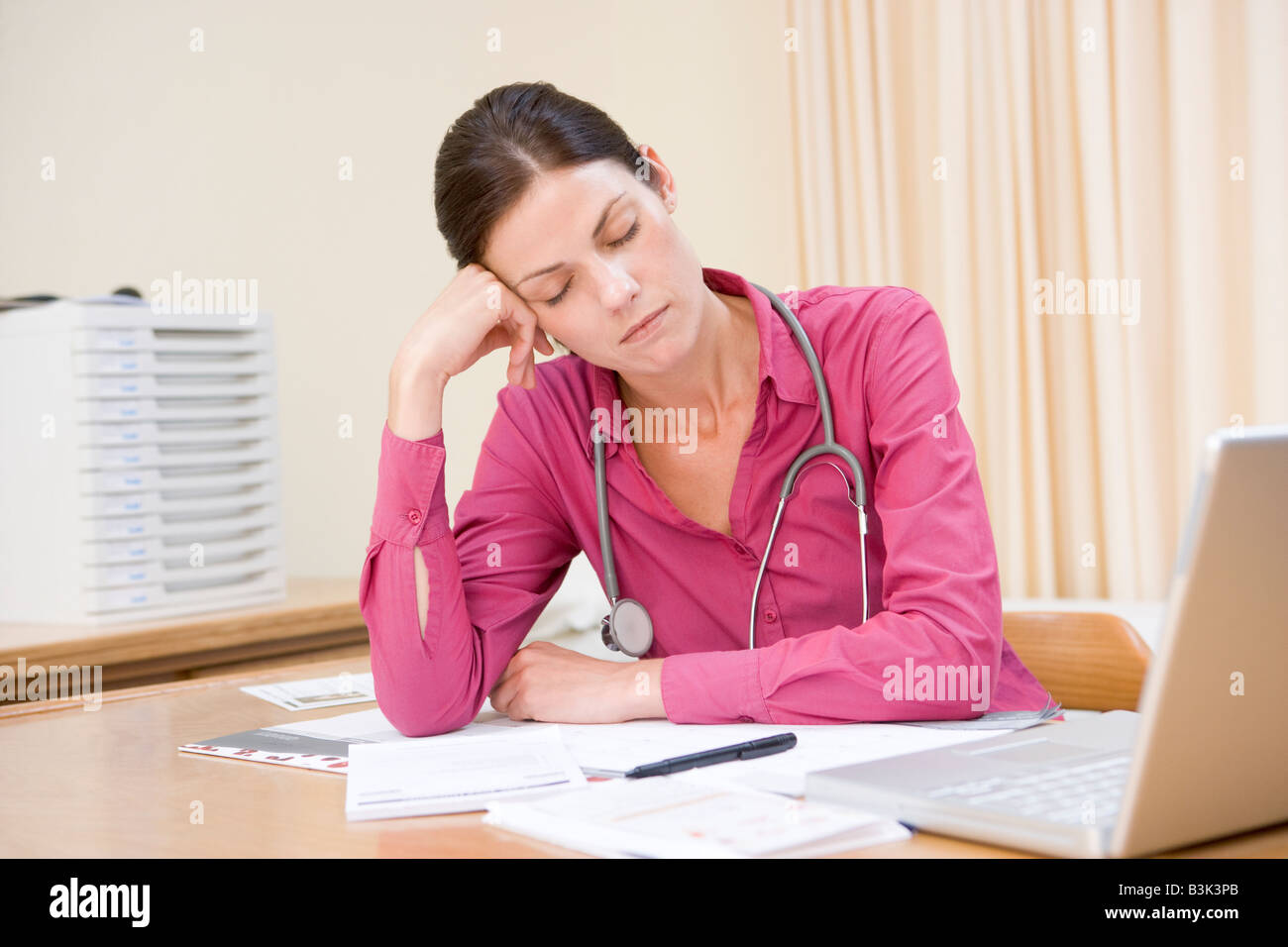 Doctor with laptop sleeping in doctor's office Stock Photo - Alamy