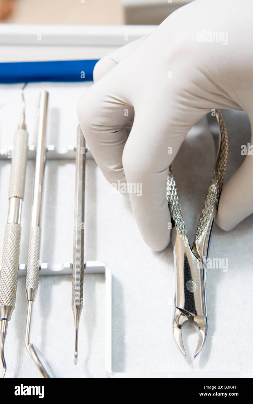 Dental tools with a gloved hand Stock Photo