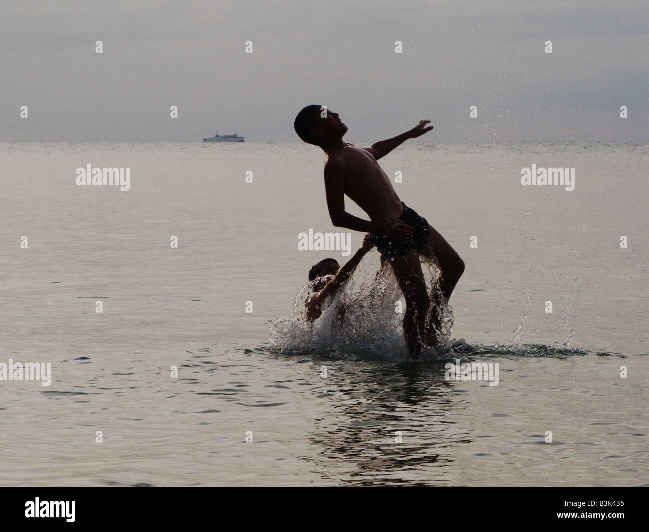 two boys playing in the sea Stock Photo - Alamy