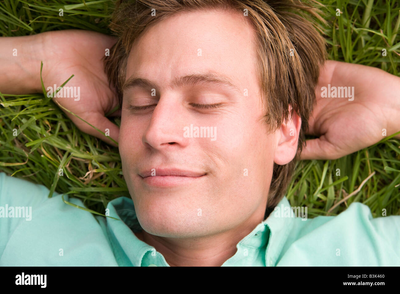 Man lying on grass sleeping Stock Photo Alamy