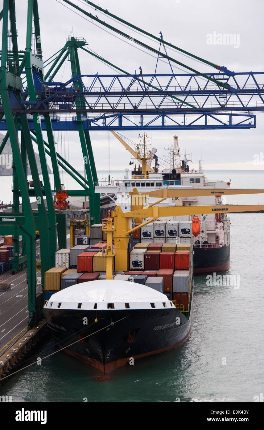 A view along the quayside of the container terminal showing shipping and container cranes. Stock Photo