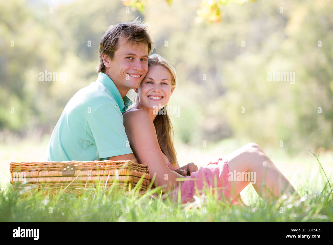 Couple at park having a picnic and smiling Stock Photo